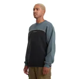 Buzo de cuello redondo Volcom, confeccionado en tejido polar de corte holgado. Diseño en bloques de color verde oscuro y negro, separado por una línea curva contrastante con el logo de la marca bordado en el centro del pecho.