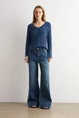 Pantalón de jean wide leg en color blanco, de tiro alto y corte ancho con dobladillo ancho en los bajos.