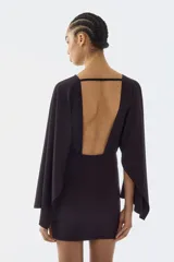 Vestido corto de punto fino en color negro, con escote bote, costura fruncida en la cintura y mangas capa largas con diseño abultado.