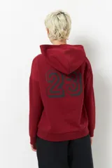 Canguro beige de algodón con capucha, manga larga y estampado frontal con la leyenda "Sport Club 23". También tiene estampado en las mangas.