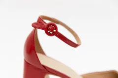 Zapatos de tacón con plataforma, color rojo, con correa al tobillo y hebilla redonda.