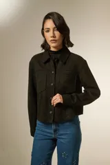 Sobrecamisa de textura gamuzada en color negro, con cuello clásico, cierre frontal de botones y dos bolsillos frontales con solapa.