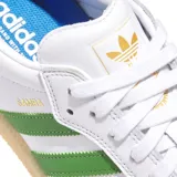 Championes Adidas Samba Adv, color blanco con detalles en verde y suela color caramelo.