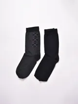 Pack de dos pares de medias de vestir para hombre: un par color gris oscuro con diseño de rombos y otro par color negro liso.