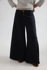 Pantalón de tiro medio con diseño de pierna ancha y cortes curvos que aportan movimiento. Presenta cintura ajustada, bolsillos delanteros y bolsillos plaque en la parte trasera.