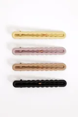 Set de cuatro pinzas para el pelo rectangulares con bordes ondulados en colores amarillo, rosado, tostado y negro.
