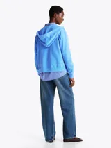 Buzo con capucha celeste de Tommy Hilfiger, con cierre de cremallera, bolsillos tipo canguro, puños y bajo de punto canalé. Logo de Tommy Hilfiger bordado en el pecho y en el ribete de la manga.