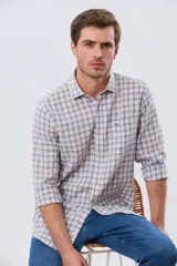 Camisa de lino con diseño a cuadros en tonos celestes y rosados, de manga larga, con cuello camisero, cierre frontal de botones y un bolsillo aplicado en el pecho con logo bordado.