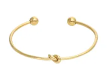 Esclava dorada de acero con detalle de nudo en el centro y terminaciones redondeadas.