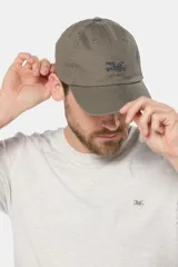 Gorro de lona color verde oliva con visera curva y logo bordado en azul marino en el frente.