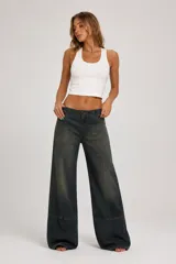 Pantalón de jean de tiro medio, corte ancho y diseño de perneras rectas con costuras frontales destacadas.