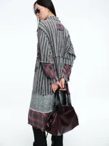 Camisa larga de diseño patchwork con cierre frontal de botones, confeccionada mediante la combinación de paneles con estampados de rayas, cuadros escoceses y motivos florales, con terminaciones deshilachadas.