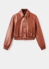 Chaqueta de cuero ovino color marrón, con diseño corto, cuello camisero, cierre frontal con botones y puños elásticos.