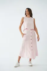 Falda midi abotonada en el frente, color rosa claro, con bolsillos laterales y diseño de corte recto.