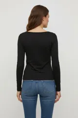 Remera blanca de manga larga, de algodón y elastano, corte ajustado y cuello redondo.