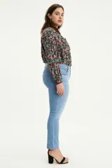 Jeans de corte skinny con tiro medio, confeccionados en denim de lavado medio claro. Presentan diseño de cinco bolsillos, cierre frontal con botón y cremallera, y costuras reforzadas.