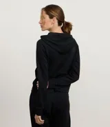 Campera deportiva con capucha ajustable, cierre frontal por cremallera, mangas largas con sisa raglán y puños ajustados. Presenta bolsillo tipo canguro y cordones con lettering estampado.