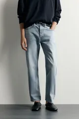 Jeans regular fit confeccionados en denim de algodón celeste con efecto lavado, de cinco bolsillos y cierre frontal con cremallera y botón.