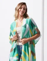 Kimono tejido de poliéster con estampado geométrico en tonos verde, amarillo, blanco y marrón. Presenta mangas amplias tipo japonesa y terminación de ruedo con borlas.