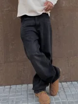Pantalón de jean negro, corte amplio y tiro alto.