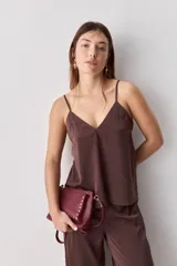 Top negro de breteles finos con escote en V y diseño minimalista, confeccionado en tela fluida y suave.
