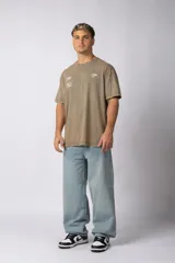 Remera de algodón con efecto lavado ácido en color gris, de corte holgado y manga corta. Presenta estampados gráficos minimalistas en el pecho y cuello redondo acanalado.