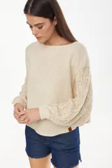 Sweater cropped de punto calado, color celeste melange, con mangas anchas de diseño holgado y cuello redondo.