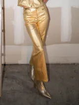 Pantalón plateado de corte recto y tiro alto, confeccionado en simil cuero.