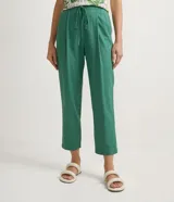 Pantalón de corte fluido y cintura media con cordón ajustable. Presenta diseño liso con bolsillos laterales y confección en tejido de viscolino.