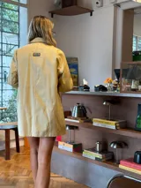 Blazer de corte oversize en color crema, con solapas clásicas, cierre frontal de botones y bolsillos laterales. Presenta una estructura relajada y mangas largas.