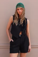 Bermuda de tusor negro con pinzas y bolsillos laterales.