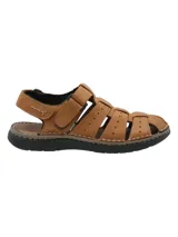 Sandalia de cuero color marrón con diseño de tiras entrelazadas y perforaciones decorativas. Cuenta con ajuste de velcro en el tobillo y suela de poliuretano negra con costuras visibles.