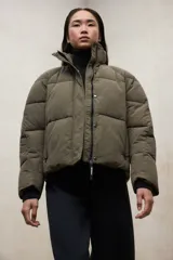 Campera acolchada color verde oliva, de corte oversize y cuello alto, con cierre frontal y puños de punto.