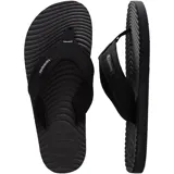 Ojotas Havaianas Surfer Coast, color negro, con tiras de tela texturizada y suela con diseño ondulado.