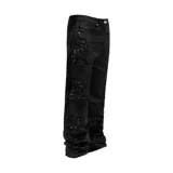Pantalón flared negro con detalles de bordados florales en cuentas en los laterales de las piernas.
