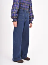 Jean de corte recto y tiro alto, color negro, con bolsillos frontales tipo parche.