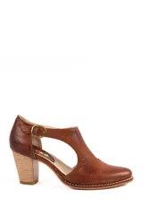 Zapato guillermina artesanal de cuero marrón, con taco alto ancho símil madera, puntera redondeada y tira en el empeine con hebilla metálica dorada.