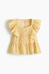 Top de algodón amarillo con estampado floreado, escote corazón, volados en los hombros y detalle de peplum en la cintura.