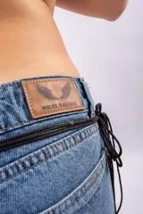 Jean de corte wide leg y tiro bajo, confeccionado en denim rígido de color azul clásico. Presenta un diseño de pierna ancha y recta, con costuras reforzadas y cierre frontal con botón.