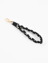Llavero de muñeca tejido en hilo de algodón negro con detalles de hilo blanco formando cruces. Incluye mosquetón metálico dorado.
