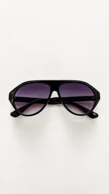 Lentes de sol tipo aviador con armazón negro de acetato y cristales degradados en tonos morados, con protección UV400.