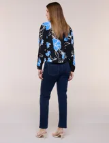 Camperita liviana de silueta entallada con estampado abstracto en tonos de azul y blanco, cuello camisero, cierre frontal con botones, bolsillos en el pecho con solapa y mangas largas.