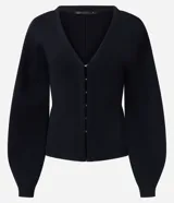 Cardigan de punto negro con escote en V, cierre frontal mediante ganchos metálicos y mangas largas con puños ajustados. Presenta un diseño entallado en la cintura con mangas ligeramente abullonadas.