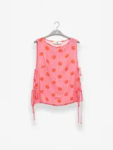 Musculosa marrón con estampado animal print, de corte holgado y lazos laterales ajustables.