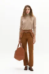 Pantalón de gamuza color marrón, de corte recto con tajos en el ruedo. Presenta un diseño de tiro medio con cinturón integrado que incluye bolsillos laterales tipo cartuchera.