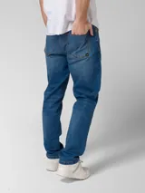 Pantalón de jean azul índigo con diseño clásico de cinco bolsillos, cierre de cremallera y botón metálico. Presenta corte de pierna delgada, remaches con logo en bolsillos delanteros y parche de marca en la cintura trasera.