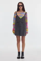 Monoprenda corta de denim color gris oscuro, de corte oversize, con tirantes regulables y bolsillo canguro frontal.