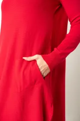 Buzo largo de punto color blanco, con cuello redondo, bolsillos delanteros y aberturas laterales.