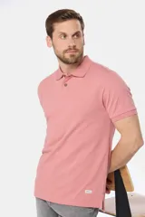 Remera polo de piqué, color rosado, de manga corta y cuello con botones personalizados.