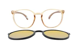 Lentes ópticos MDQ modelo Anut Miel con armazón redondo de acetato color miel y clip-on polarizado de sol en color negro con lentes amarillos.